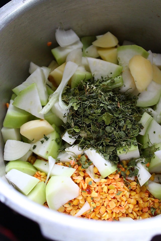 chopped vegetables, lentils and dried fenugreek leaves added in a pressure cooker. 