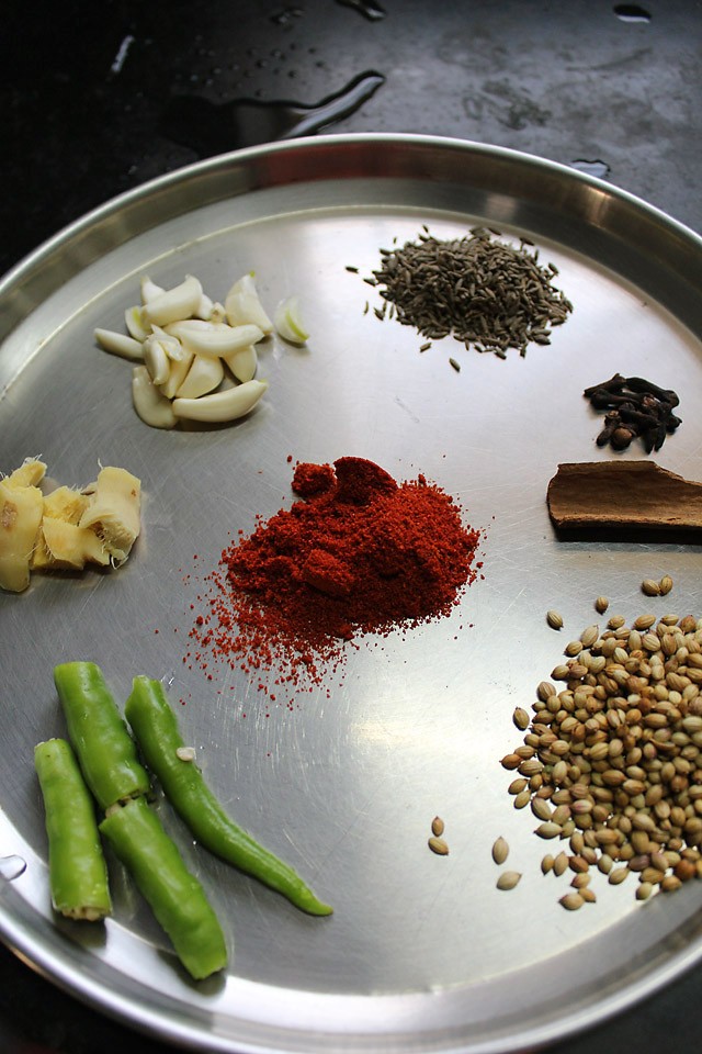 ingredients for dhansak masala on a steel plate. 