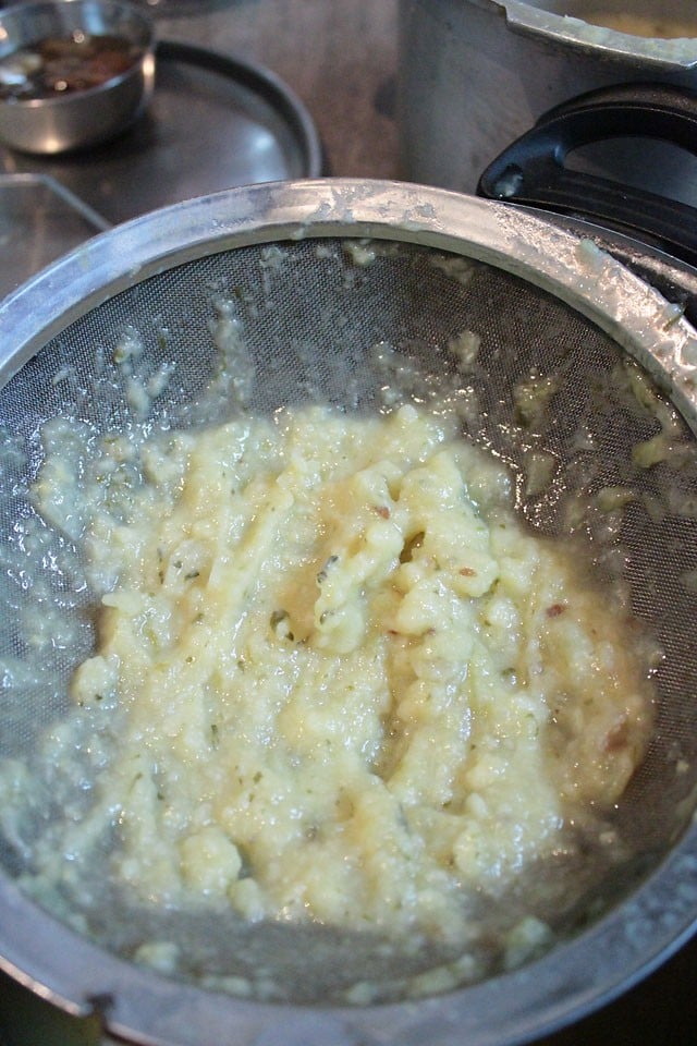 mashed vegetables and lentils in the strainer. 