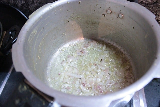 sautéing onions in hot ghee for making dhansak. 