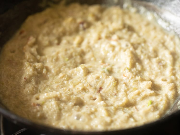 cook till the halwa mixture starts coming together and thickens