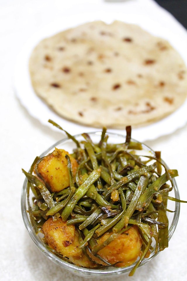 sautéed radish pods and potatoes in a glass bowl.