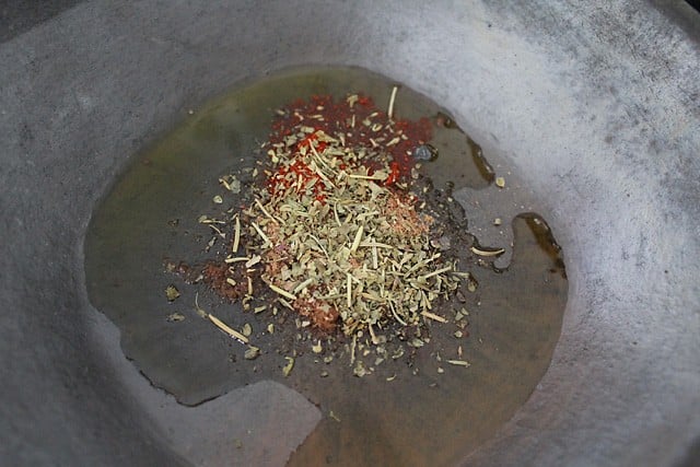 herbs, salt, and oil added to baking tray.