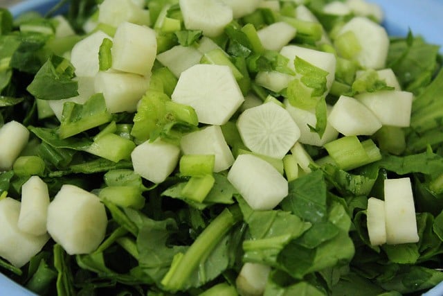 adding chopped radish for palak saag