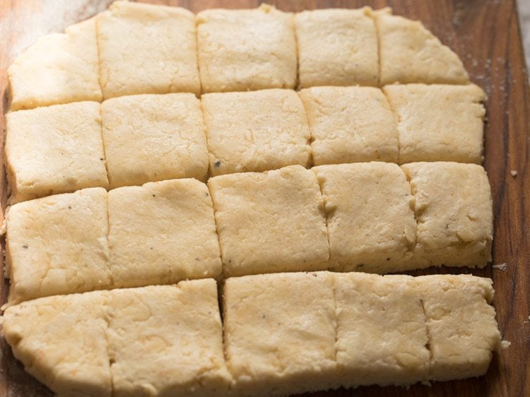 cutting cheese biscuits dough into biscuits