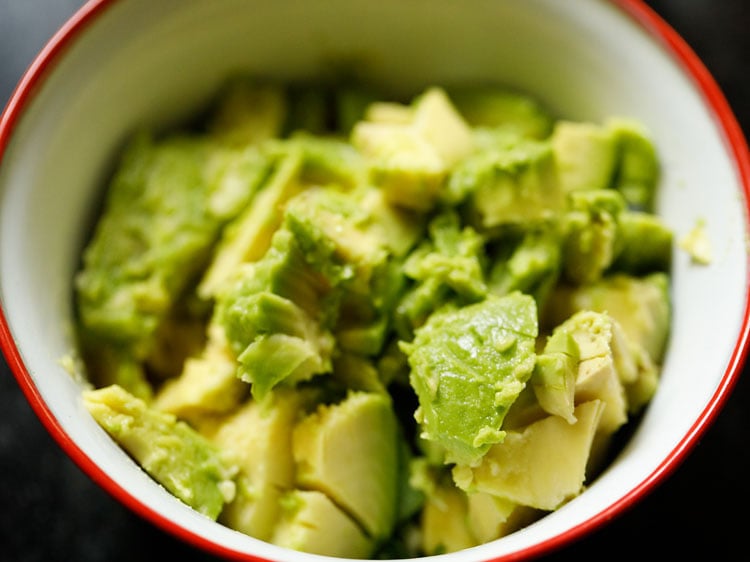 chopped avocado added in the mixing bowl for making guacamole.