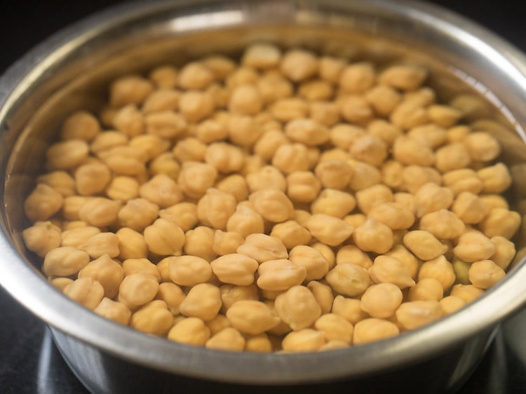 dried chickpeas soaked in water in a bowl