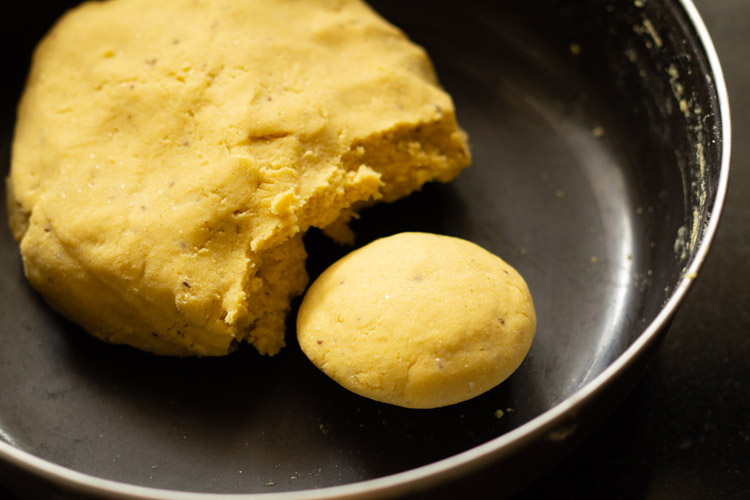 flattened dough ball portioned from dough in bowl