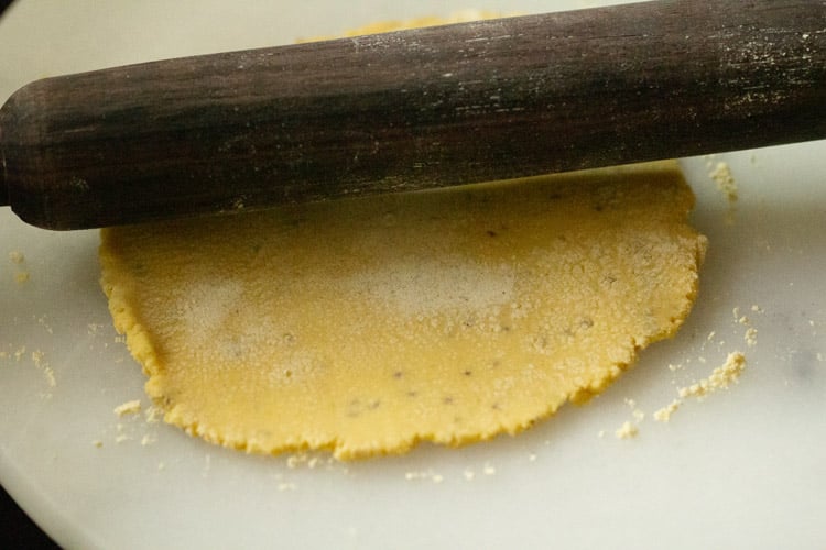 rolling dough with rolling pin to make flatbread