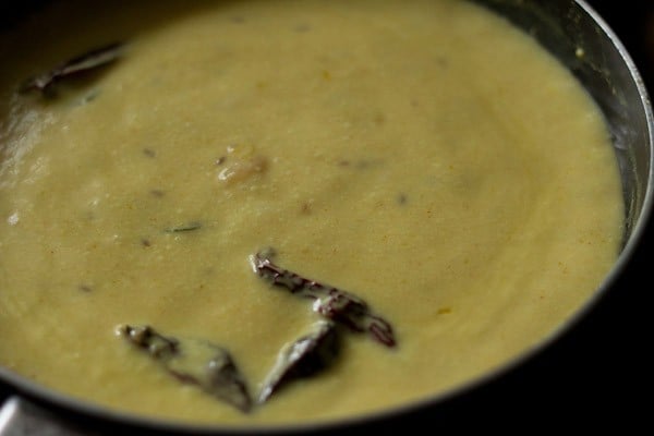 cooking kadhi to make punjabi kadhi pakoda