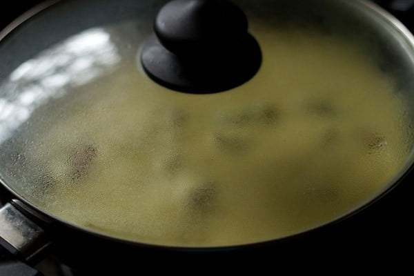 kadhi pakora in the pan covered with a glass lid
