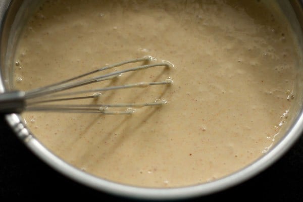 curd mixture being mixed with wired whisk
