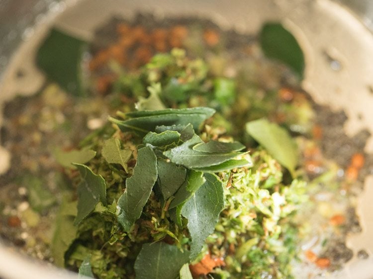 chopped curry leaves added for making thakkali rasam. 