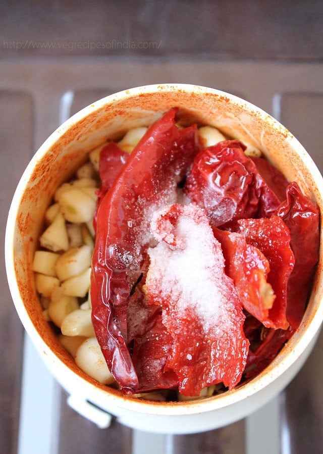 ingredients in a wet grinder for red garlic chutney. 