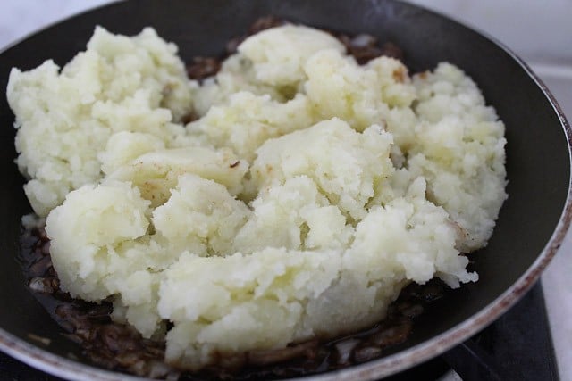 mashed potatoes added to the pan. 
