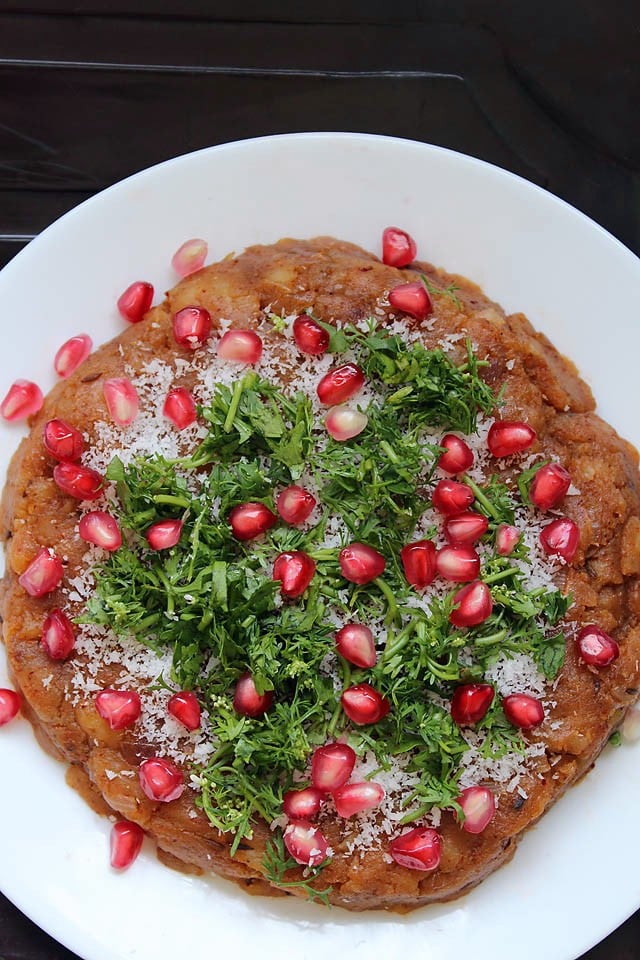 fresh pomegranate pearls on top of the cooked potato filling. 