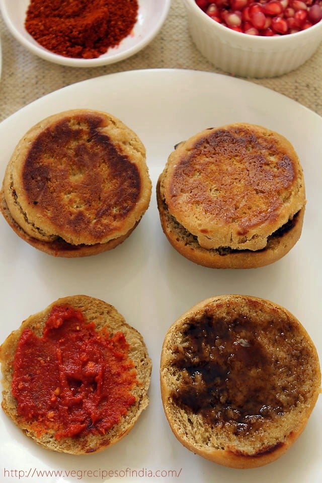 tamarind chutney and red garlic chutney applied on roasted bun halves. 