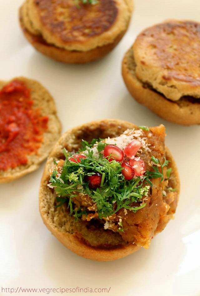 portion of cooked potato filling on top of one roasted bun half. 