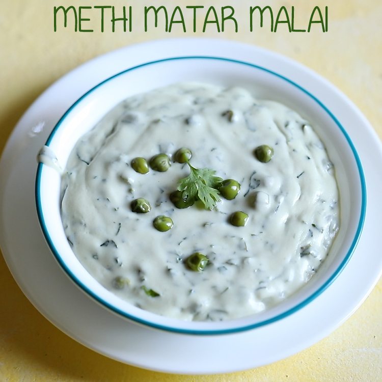 methi matar malai in a white bowl with a light blue rim, garnished with a few peas and a sprig of fresh coriander.