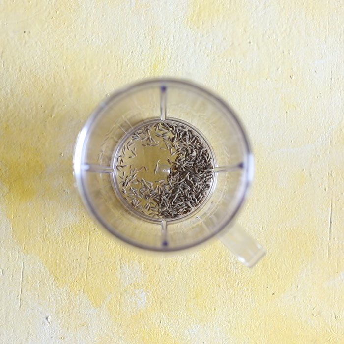 cumin seeds in a grinder jar.
