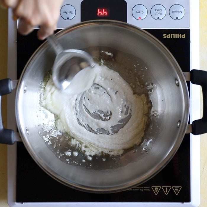 sautéing the paste to make methi matar malai recipe.