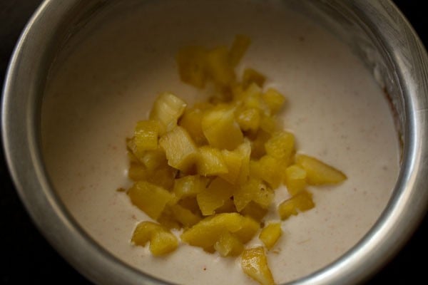 cubed pineapple added to raita base