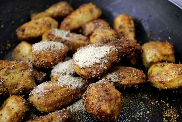 dried mango powder added to the arbi in the pan. 