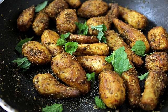 chopped mint leaves added to arbi sabji in the pan. 