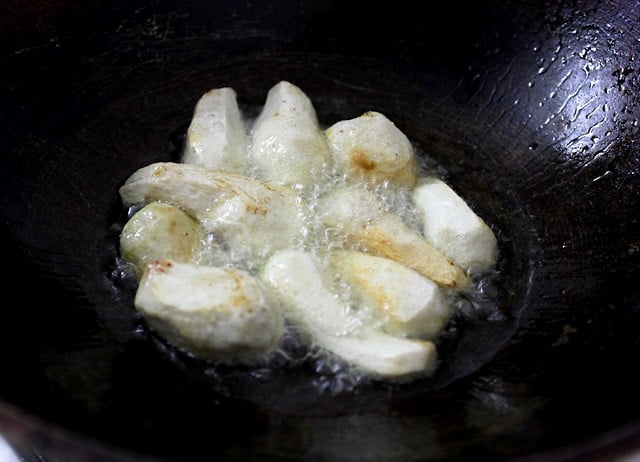 frying arbi pieces in hot oil. 