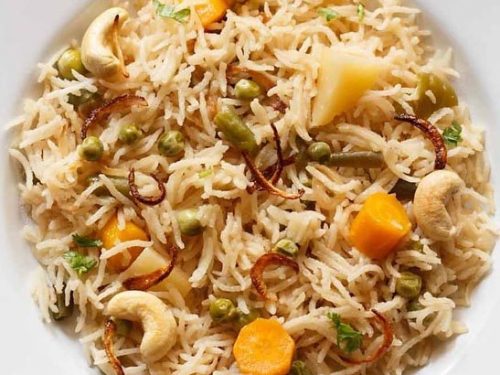 yakhni pulao on a white plate