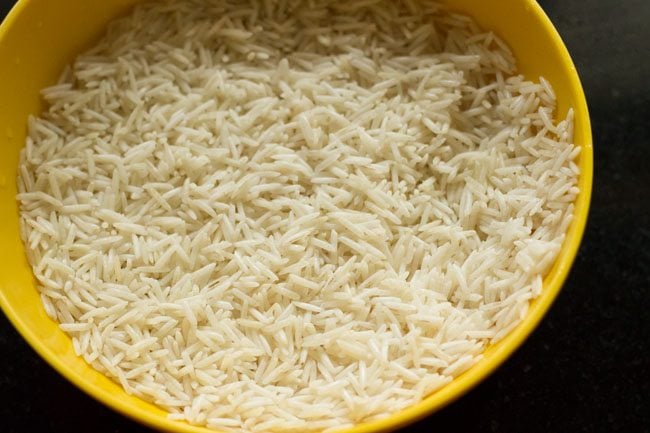 soaked basmati rice in yellow bowl