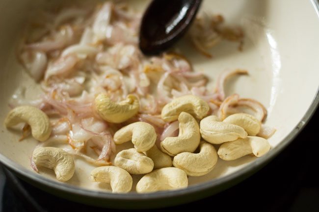 cashews and onions in pan