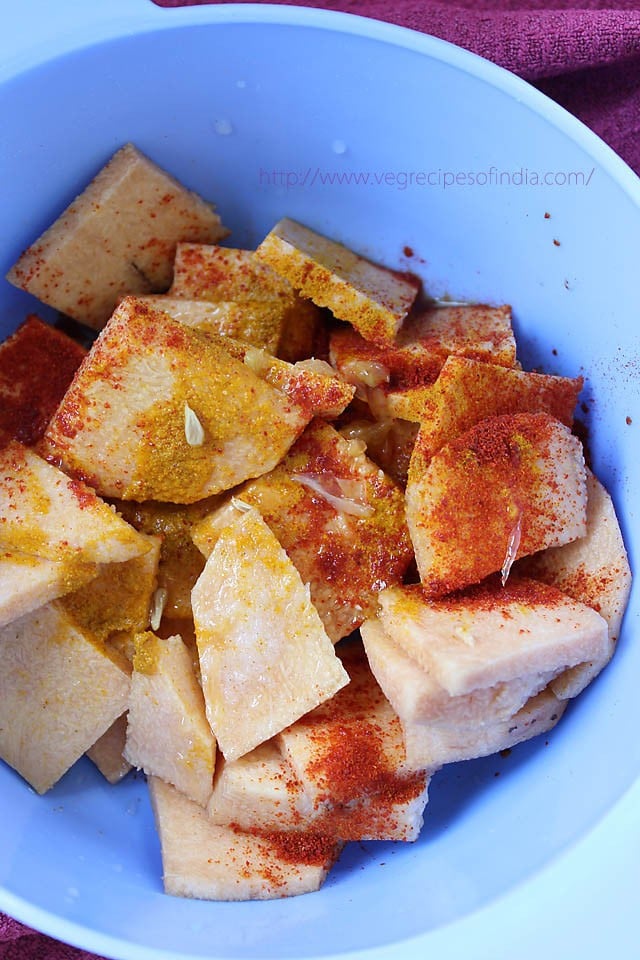 sliced yam or jimikand marinated with turmeric powder, red chili powder, lemon juice and salt. 