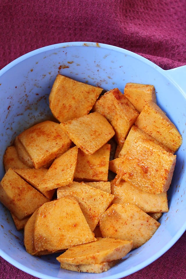 marinating yam or jimikand slices in a bowl. 