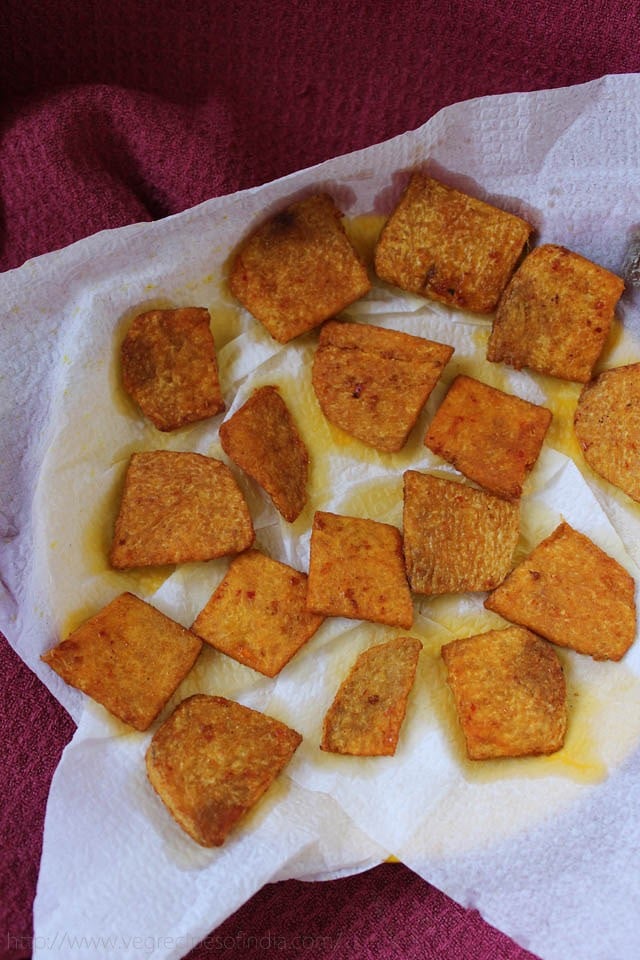 draining fried yam chips on a kitchen tissue. 