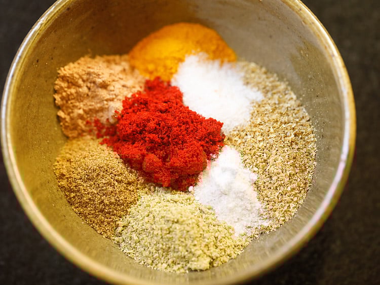 dry spice powders, black salt and salt added in a bowl.
