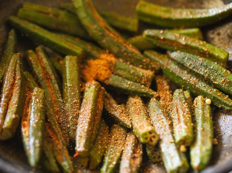 adding leftover masala to bharwa bhindi.