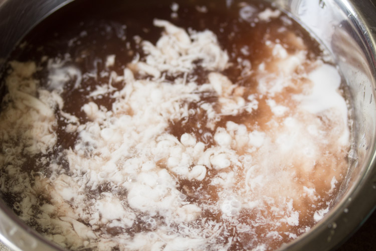 coconut milk added to kokum extract for making sol kadhi recipe.