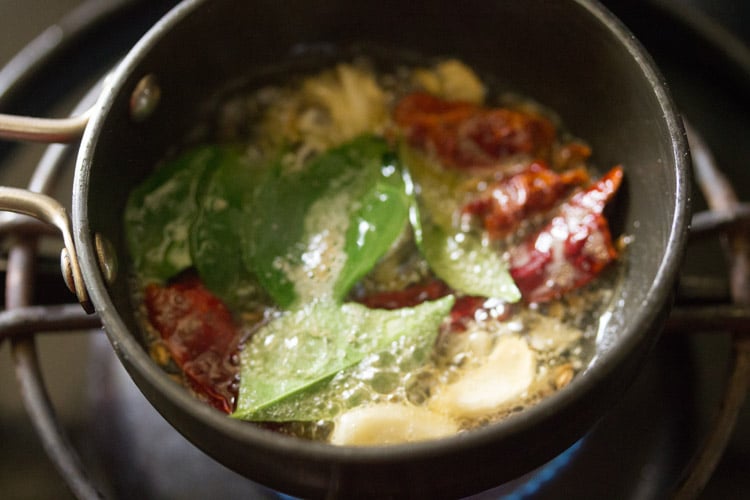 frying herbs, spices in the tadka pan.