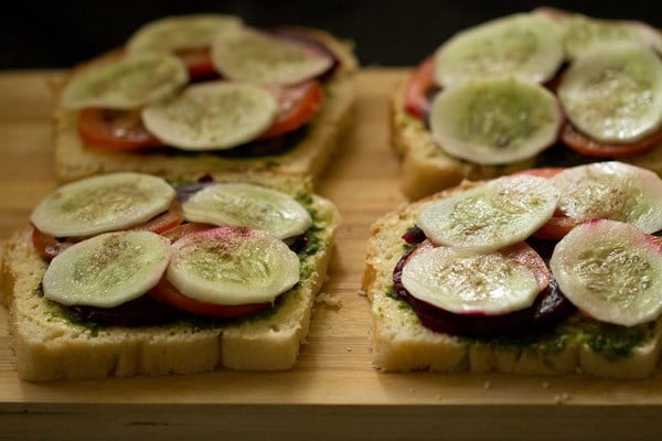 cucumber slices and seasoning on bread slices.