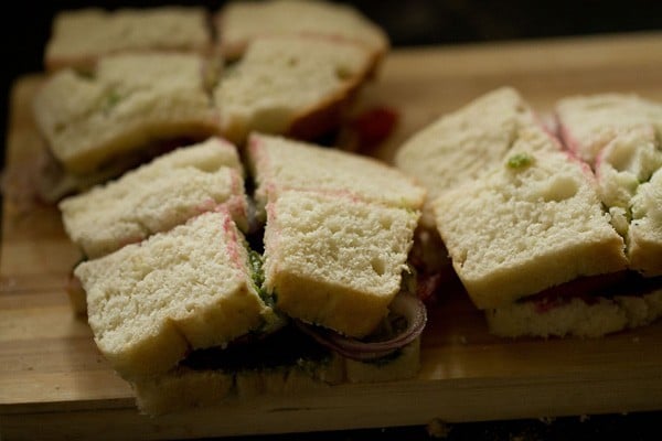 veg sandwich sliced into 4 pieces. 