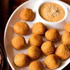 falafel served in a chip and dip platter with muhammara