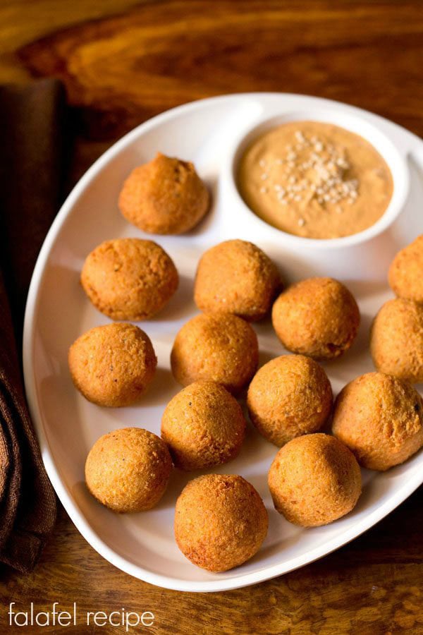 falafel served in a chip and dip platter with muhammara