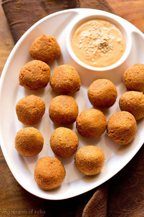 falafel served in a chip and dip platter with muhammara