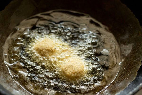 medium sized balls of falafel mixture placed in hot oil