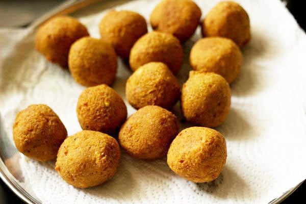 many fried falafel balls placed on kitchen paper towel