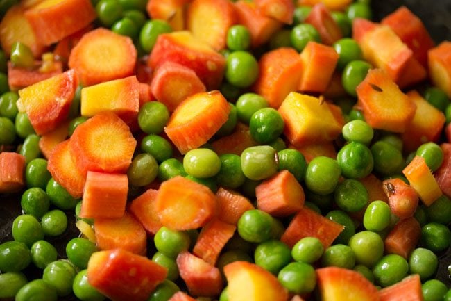 sauteing the carrots peas