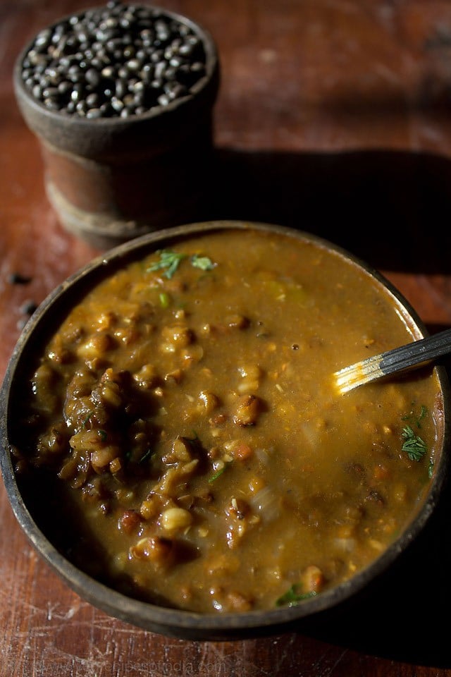 kali dal served in a bowl with spoon