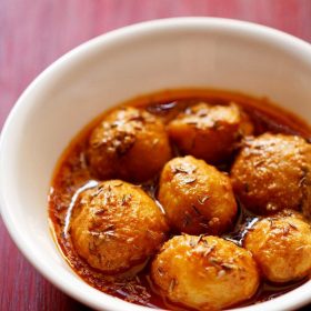 kashmiri dum aloo served in a white bowl.