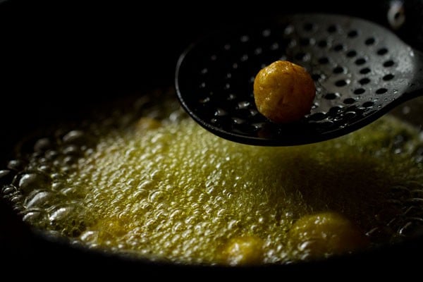 frying boiled potatoes in hot mustard oil in a pan.